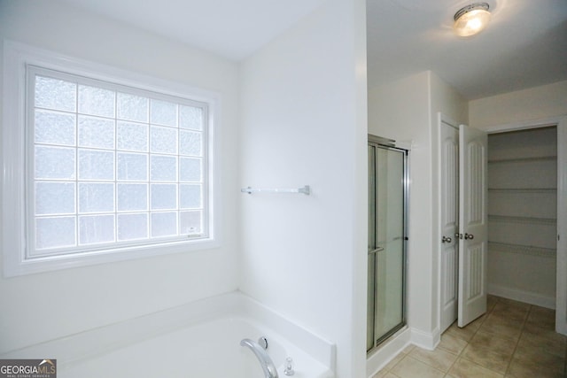 bathroom featuring tile patterned flooring and plus walk in shower