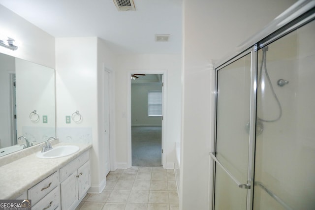 bathroom featuring vanity, ceiling fan, and a shower with shower door