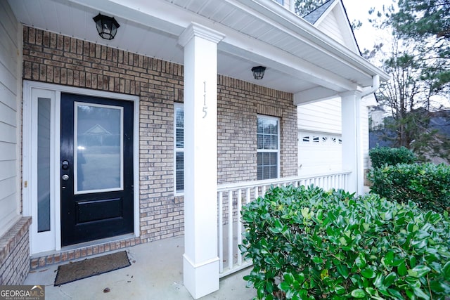 view of exterior entry with a porch