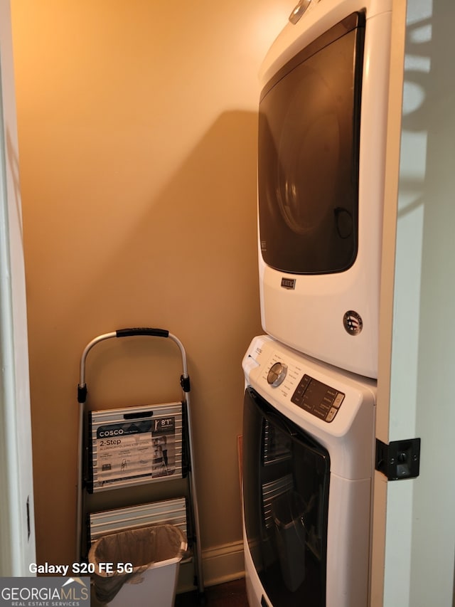 laundry area featuring stacked washing maching and dryer