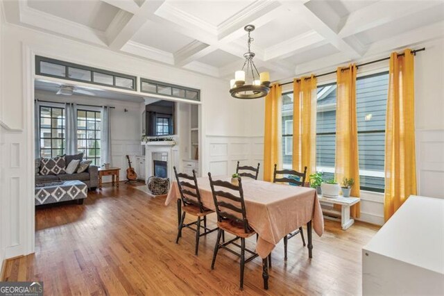 bedroom with carpet flooring, a raised ceiling, ceiling fan, and ornamental molding