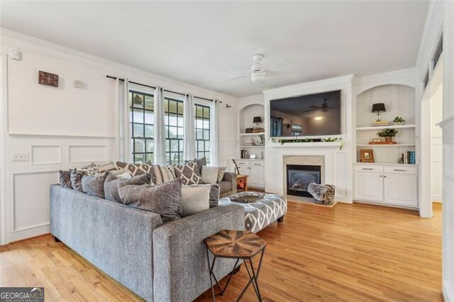 foyer with light wood-type flooring and crown molding