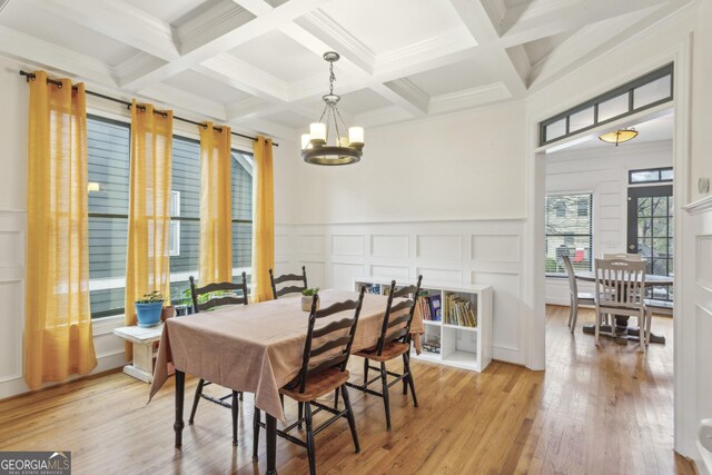 living room featuring hardwood / wood-style floors, ceiling fan with notable chandelier, and crown molding