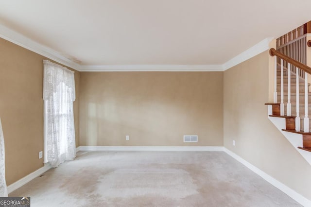 spare room with light colored carpet and crown molding