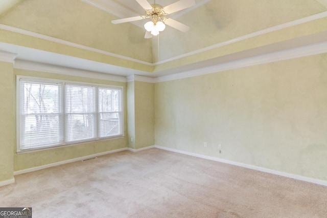 carpeted spare room with a high ceiling, ceiling fan, and ornamental molding