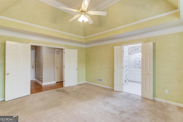 unfurnished bedroom with carpet floors, ceiling fan, crown molding, and connected bathroom