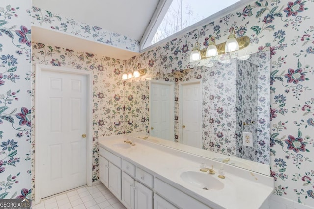 bathroom featuring tile patterned flooring, vanity, and lofted ceiling