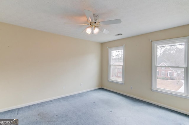 carpeted empty room with ceiling fan