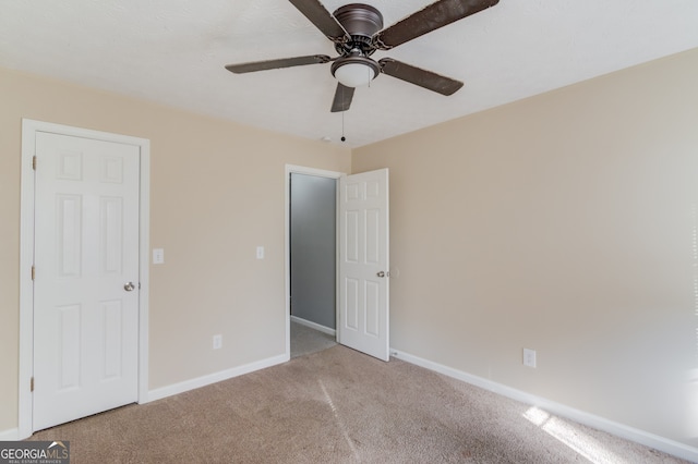 unfurnished bedroom featuring ceiling fan and light carpet