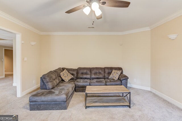 living room featuring ceiling fan, crown molding, and light carpet