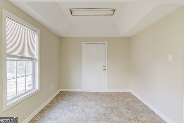 spare room featuring a tray ceiling