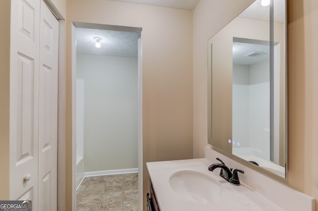 bathroom featuring vanity and a textured ceiling