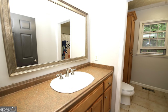 bathroom with tile patterned floors, vanity, and toilet