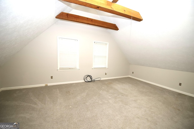 bonus room with carpet and lofted ceiling with beams