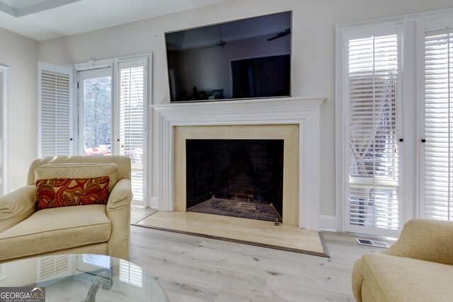 living room with hardwood / wood-style flooring and a premium fireplace