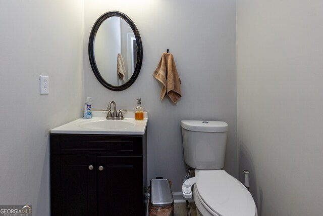 bathroom featuring vanity and toilet