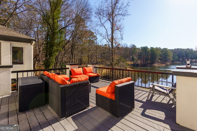 deck featuring an outdoor hangout area and a water view