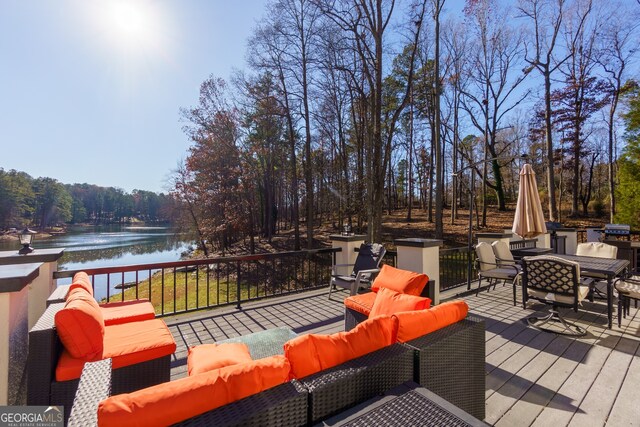 wooden terrace with outdoor lounge area and a water view