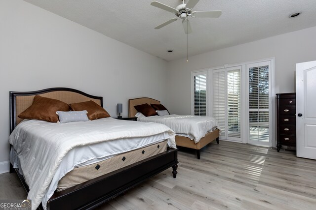 bedroom with access to exterior, light hardwood / wood-style flooring, and ceiling fan