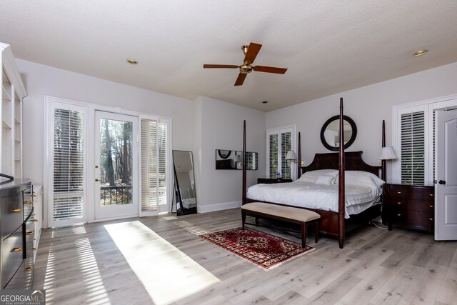 bedroom featuring ceiling fan, a textured ceiling, access to outside, and light hardwood / wood-style flooring