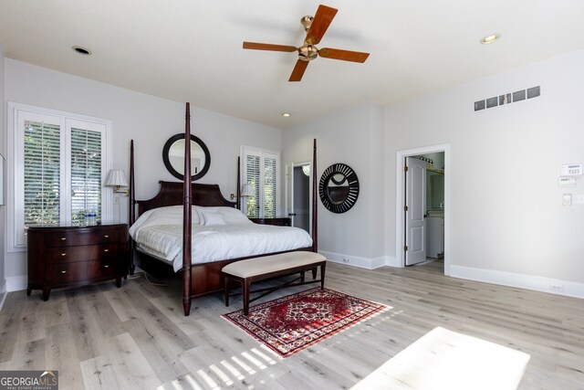 bedroom featuring ceiling fan, light wood-type flooring, and ensuite bathroom