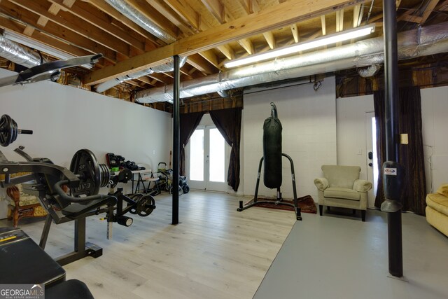 exercise room with light hardwood / wood-style flooring