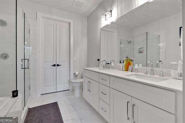 full bath featuring a stall shower, a sink, toilet, and double vanity