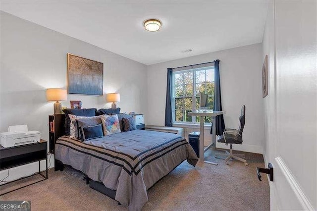 carpeted bedroom featuring baseboards