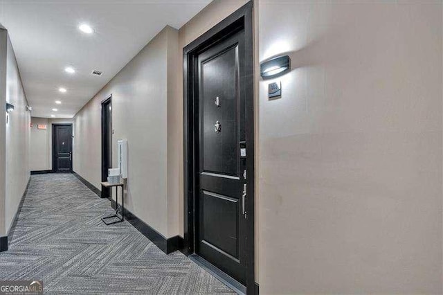 hallway featuring carpet, visible vents, baseboards, and recessed lighting