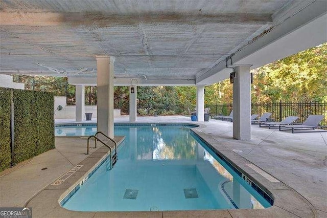 community pool featuring a patio and fence private yard