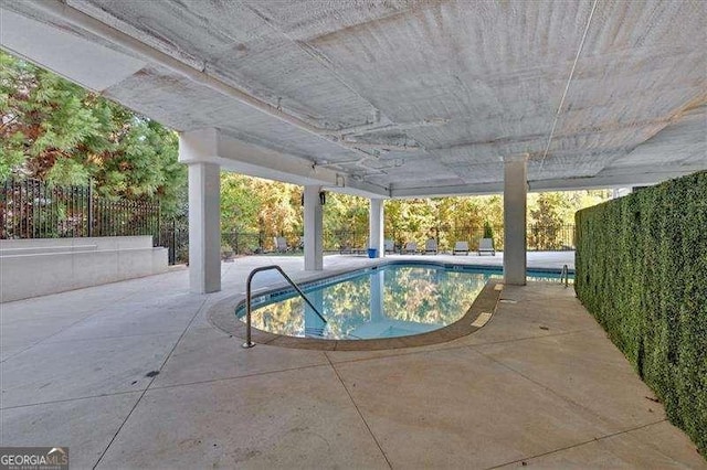 view of swimming pool with a patio, a fenced backyard, and a pool