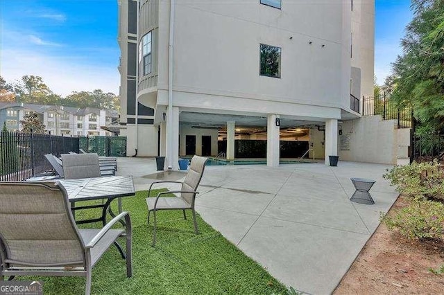 back of house with fence, a lawn, and a patio