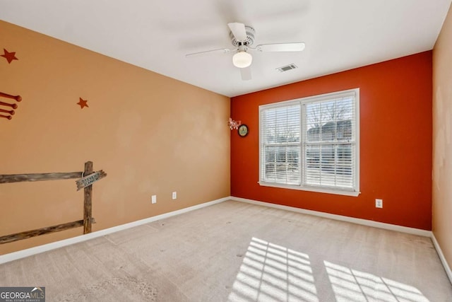 carpeted spare room with ceiling fan