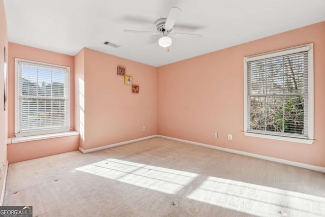 unfurnished room with ceiling fan and light carpet