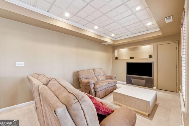 living room featuring a tray ceiling and light colored carpet