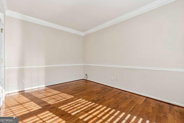 unfurnished room with hardwood / wood-style floors and crown molding