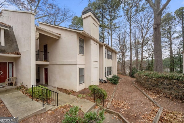 view of side of home featuring a balcony