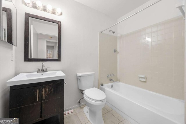 full bathroom with tile patterned floors, vanity, toilet, and tiled shower / bath