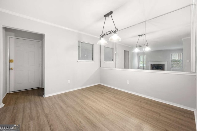 unfurnished dining area featuring crown molding and wood-type flooring