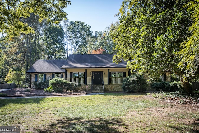 view of front of home with covered porch and a front lawn