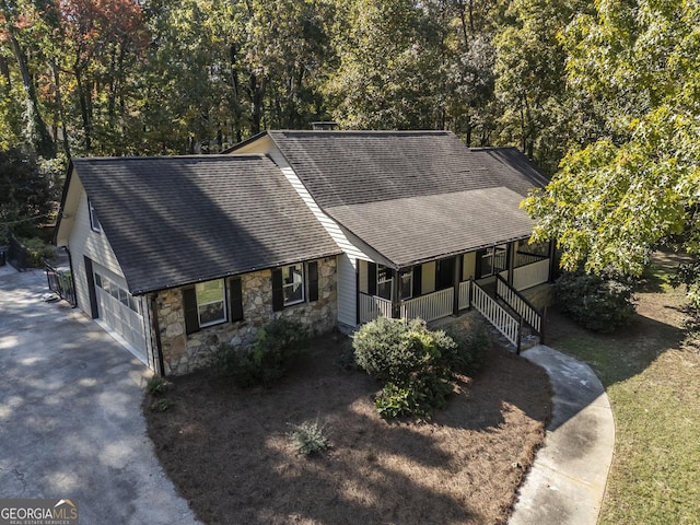 ranch-style house featuring covered porch and a garage