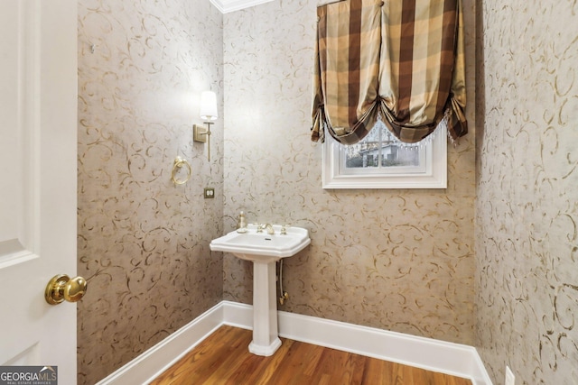 bathroom featuring hardwood / wood-style flooring and ornamental molding