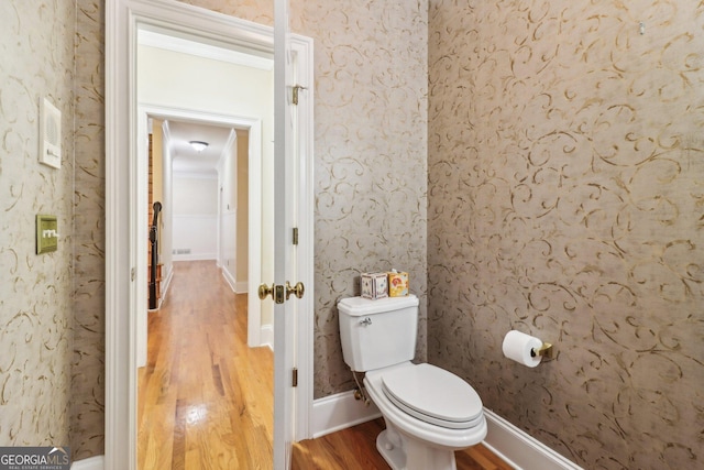 bathroom featuring wood-type flooring and toilet