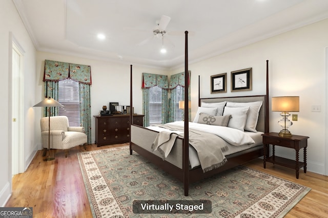 bedroom featuring ceiling fan, light hardwood / wood-style flooring, and ornamental molding