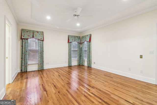 empty room featuring light hardwood / wood-style floors, ceiling fan, and crown molding