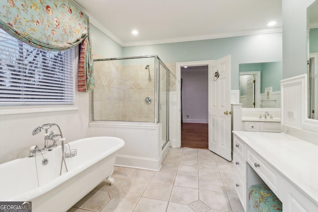 bathroom featuring tile patterned flooring, vanity, crown molding, and independent shower and bath