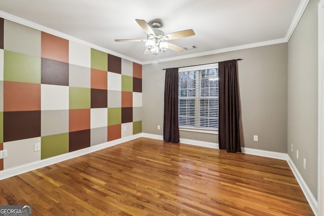 spare room featuring hardwood / wood-style flooring, ceiling fan, and crown molding