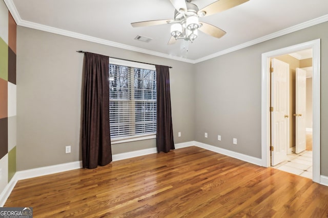 unfurnished room featuring ceiling fan, light hardwood / wood-style flooring, and ornamental molding