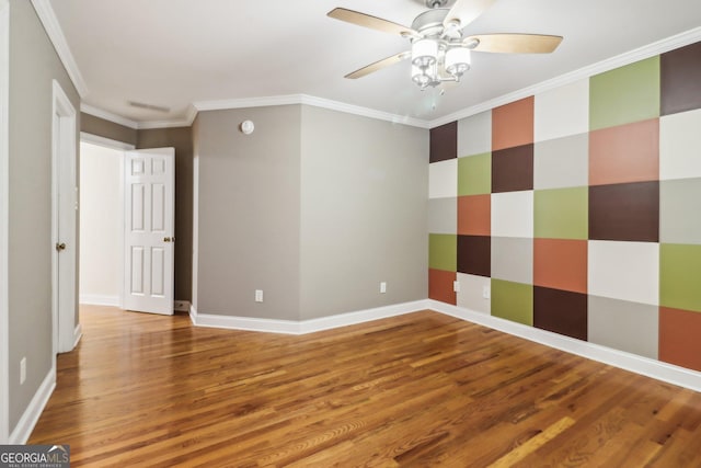 spare room with hardwood / wood-style flooring, ceiling fan, and crown molding