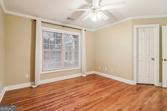 empty room with hardwood / wood-style floors, ceiling fan, and crown molding